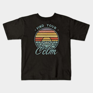 A vibrant sunset over a serene lake with the quote ‘Find Your Calm’ Kids T-Shirt